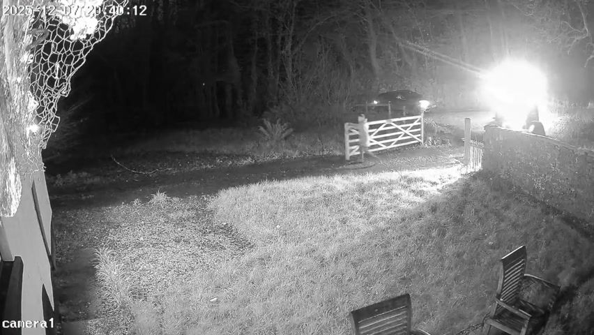 Camera still from A tractor passes beside the home